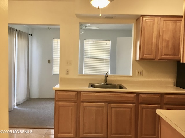 kitchen with ceiling fan, sink, and light tile patterned floors