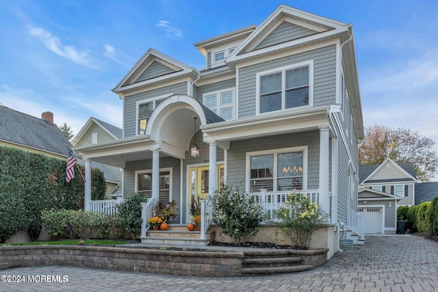 view of front of house featuring a garage and a porch