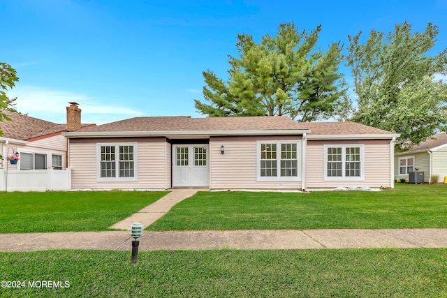 ranch-style house with a front lawn and central AC