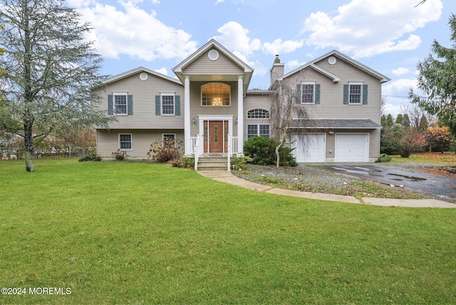 split foyer home with a garage and a front lawn