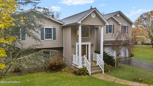 view of front of house with a garage and a front lawn