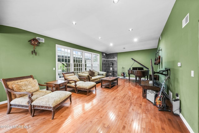 living room featuring light hardwood / wood-style flooring and a wood stove