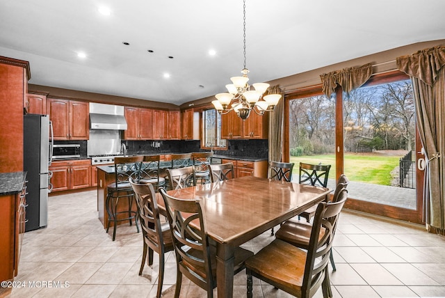 tiled dining space with a chandelier