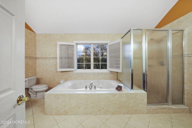 bathroom featuring tile patterned flooring, separate shower and tub, toilet, and vaulted ceiling