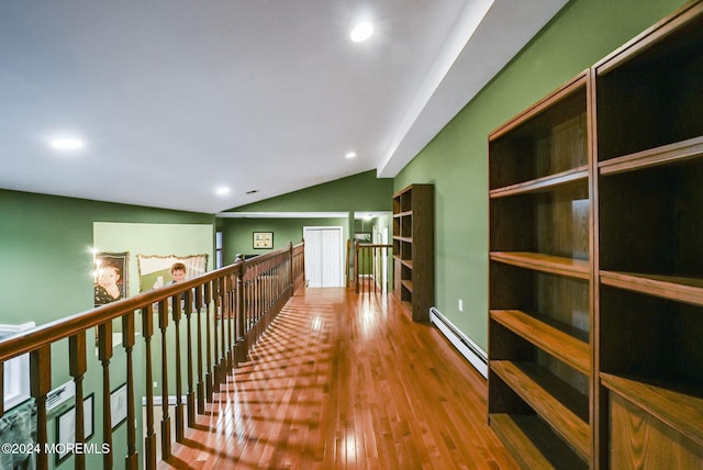 corridor featuring hardwood / wood-style flooring, vaulted ceiling, and baseboard heating