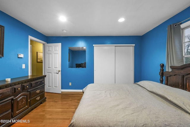 bedroom with a closet and hardwood / wood-style floors