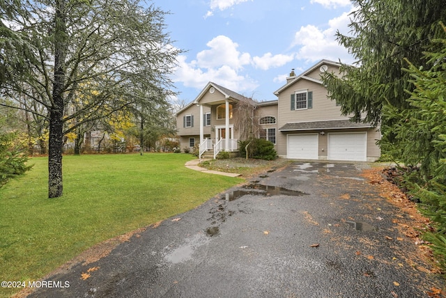 view of front of house featuring a garage and a front lawn