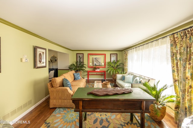 living room with hardwood / wood-style floors and crown molding