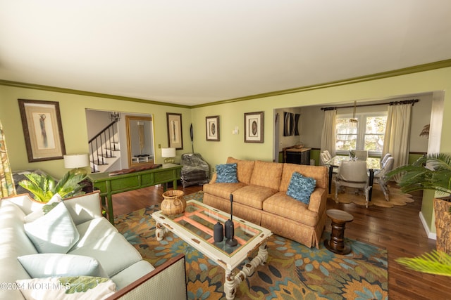 living room with dark hardwood / wood-style flooring and crown molding