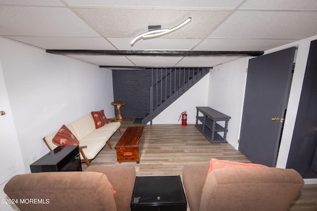 living room featuring hardwood / wood-style floors and a paneled ceiling