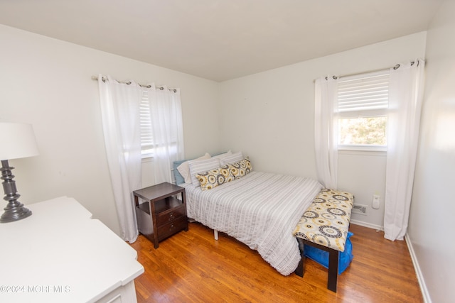 bedroom with wood-type flooring