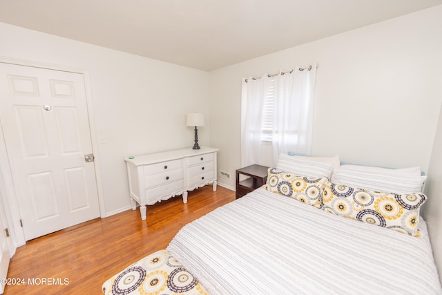 bedroom with hardwood / wood-style floors