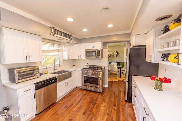 kitchen with white cabinets, stainless steel appliances, and sink