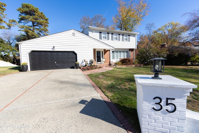 view of front property with a front yard and a garage