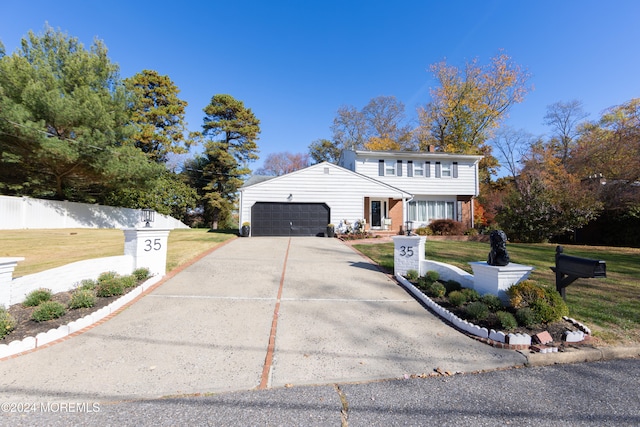 front facade with a garage and a front lawn