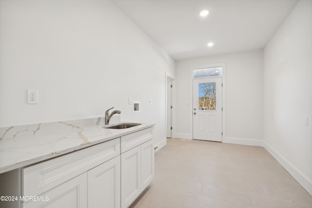 laundry room featuring cabinets, washer hookup, and sink