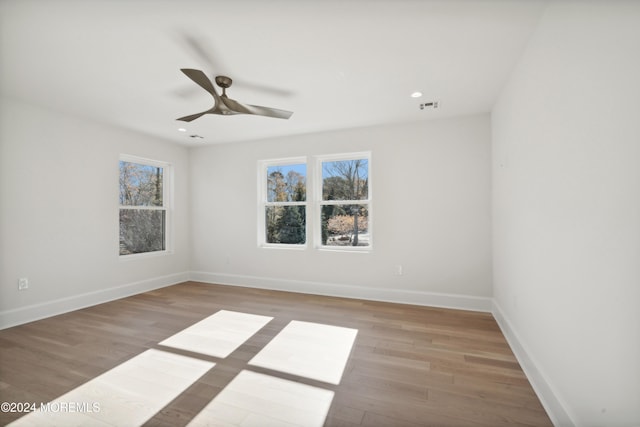 empty room with light wood-type flooring and ceiling fan