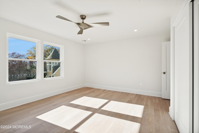 unfurnished room with light wood-type flooring and ceiling fan