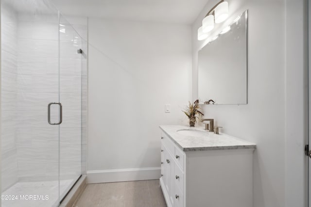 bathroom featuring vanity and a shower with shower door