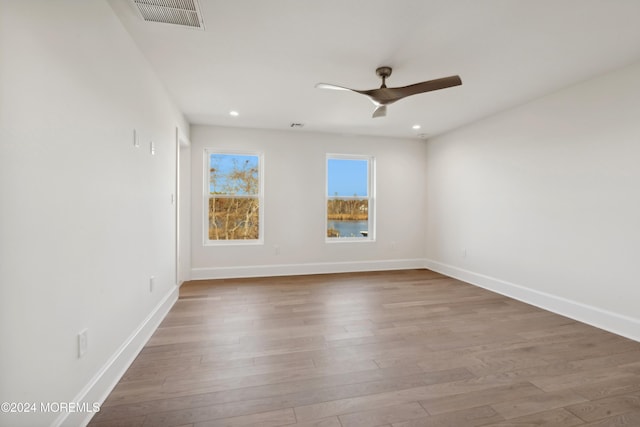 empty room with wood-type flooring and ceiling fan