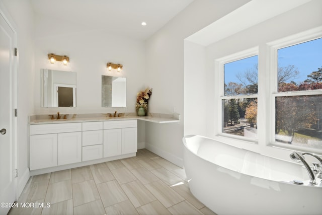 bathroom featuring a tub to relax in and vanity