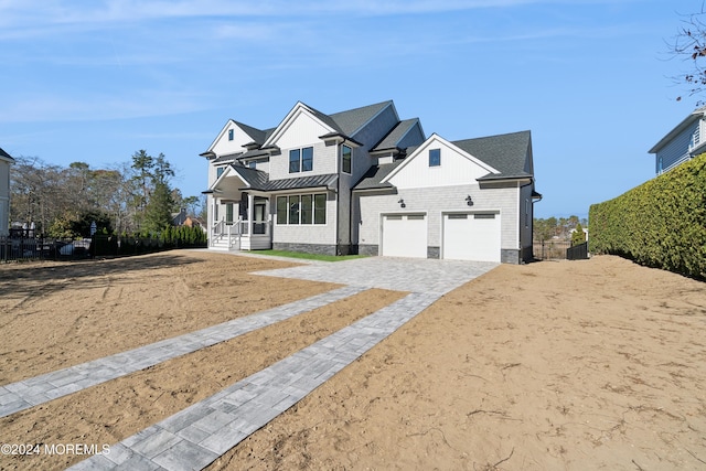 view of front of home featuring covered porch and a garage