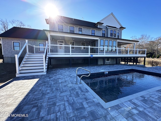 rear view of house with a swimming pool side deck