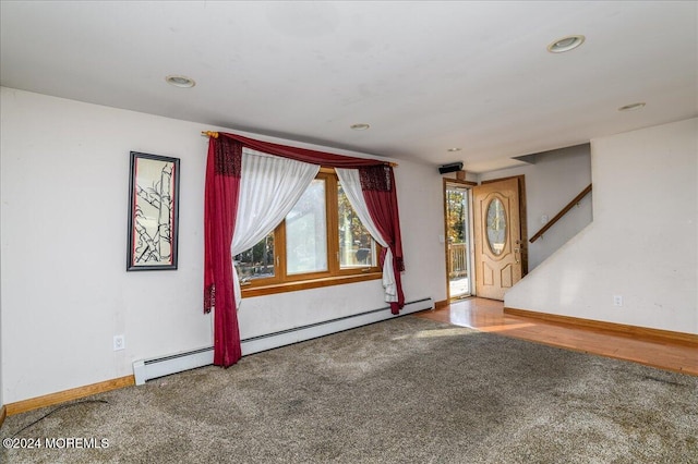 empty room with carpet and a baseboard radiator