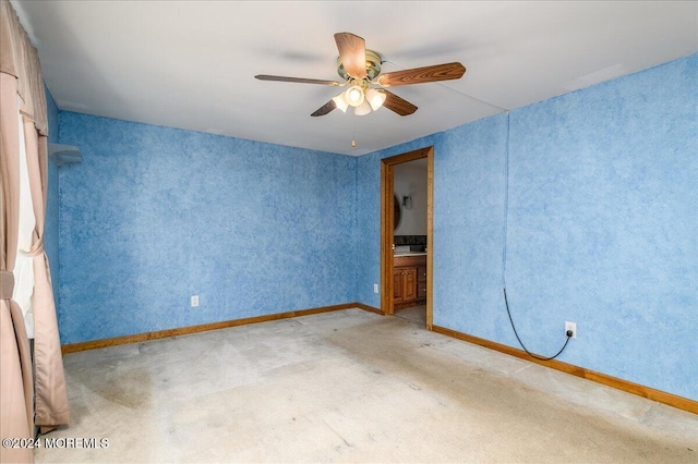 carpeted spare room with ceiling fan