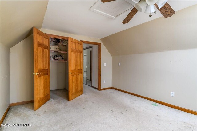 additional living space featuring lofted ceiling, light carpet, and ceiling fan