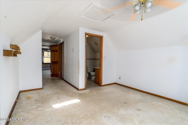 additional living space with a baseboard heating unit, light colored carpet, ceiling fan, and vaulted ceiling