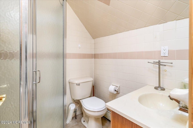 bathroom with tile walls, tile patterned floors, vanity, an enclosed shower, and toilet