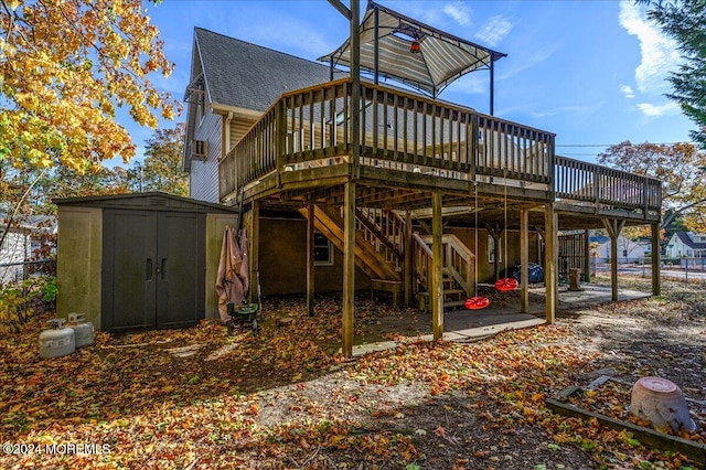 back of property with a storage unit and a deck