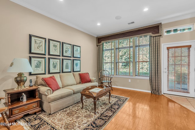 living room featuring wood-type flooring and crown molding