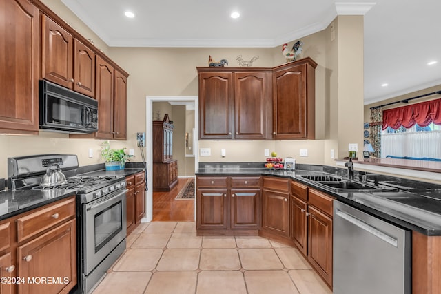 kitchen with ornamental molding, stainless steel appliances, and sink