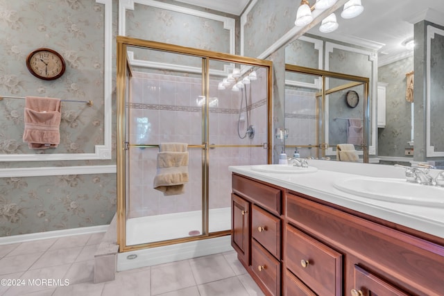 bathroom with vanity, a shower with shower door, tile patterned floors, and crown molding