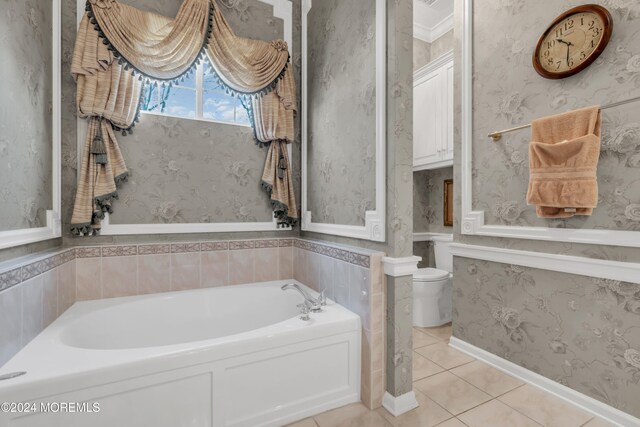 bathroom with tile patterned flooring, a tub to relax in, and toilet