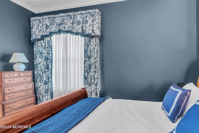 bedroom featuring multiple windows and crown molding