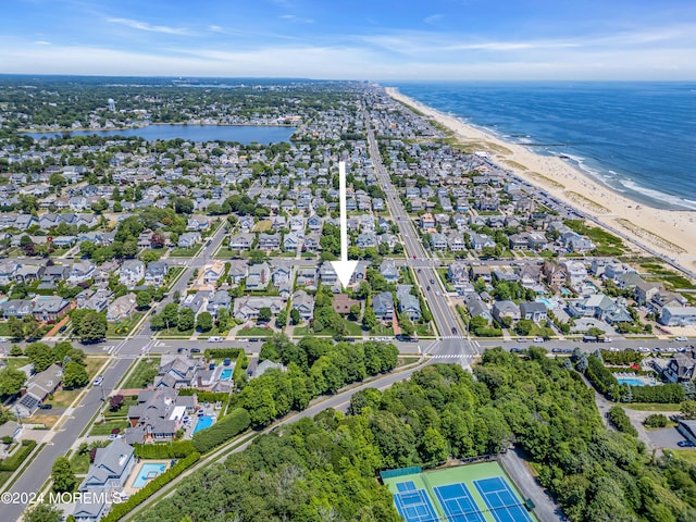 drone / aerial view featuring a water view and a beach view