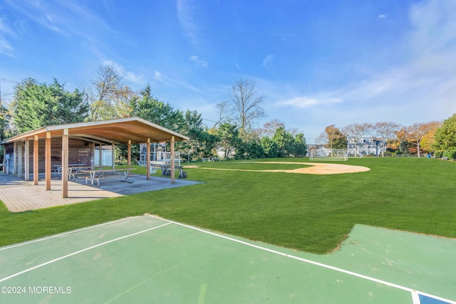 view of community with a lawn and a patio area