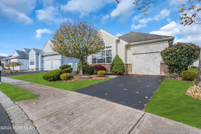 view of front of house with a garage and a front lawn