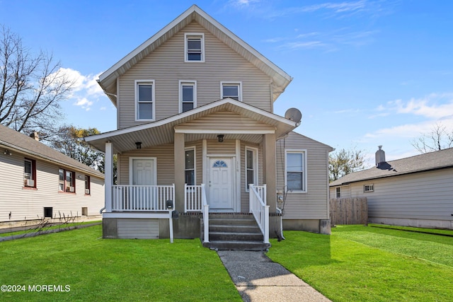 view of front of home featuring covered porch and a front yard