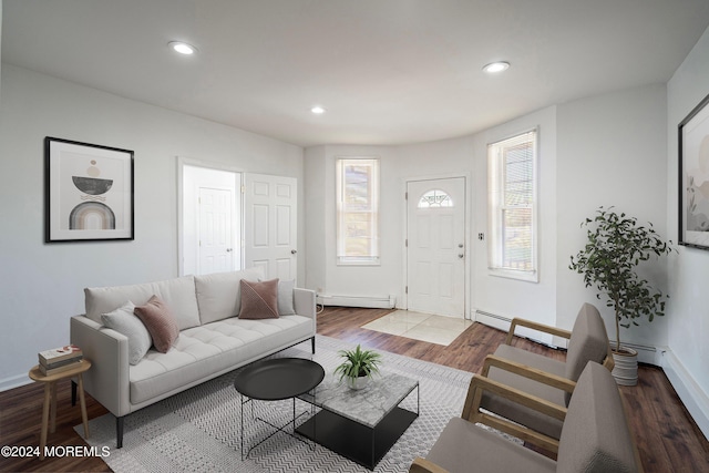 living room featuring hardwood / wood-style floors and a baseboard heating unit