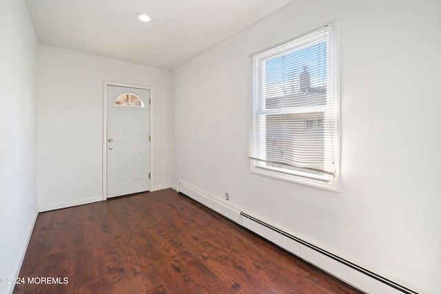 foyer featuring dark hardwood / wood-style floors and a baseboard heating unit