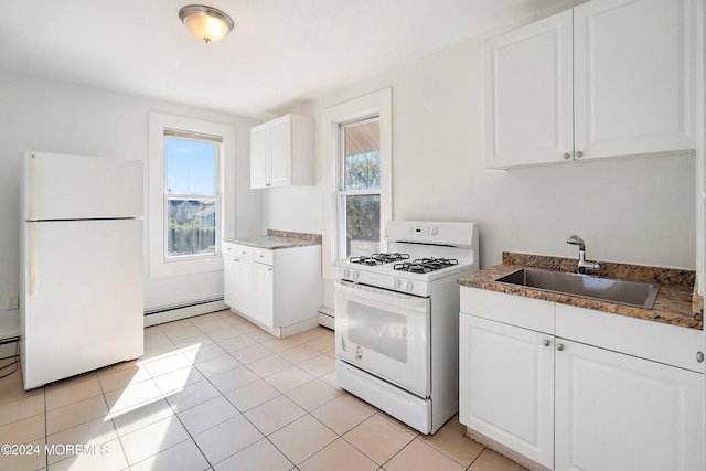 kitchen with white cabinets, plenty of natural light, sink, and white appliances