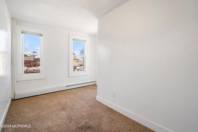 spare room with a baseboard radiator and carpet flooring