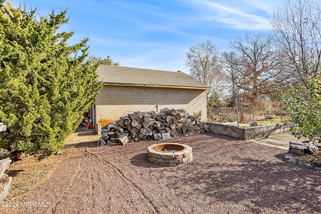 view of side of property featuring a fire pit