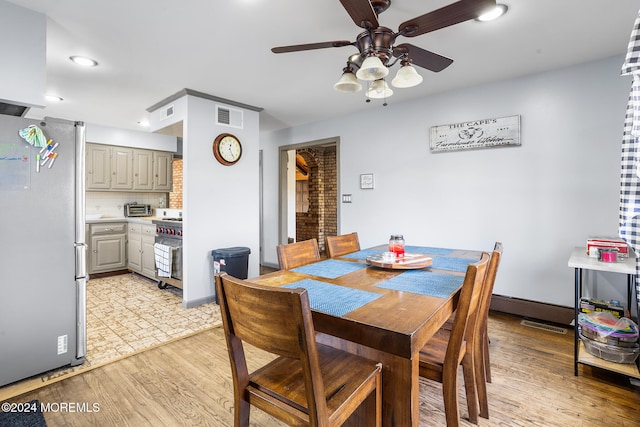 dining space featuring ceiling fan and light hardwood / wood-style flooring