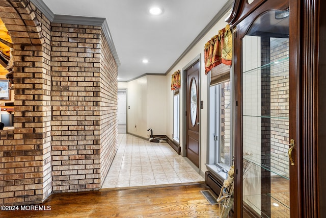 corridor featuring crown molding and light hardwood / wood-style floors