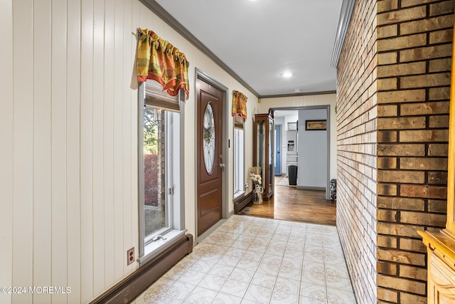 entryway featuring light hardwood / wood-style floors, a baseboard radiator, plenty of natural light, and ornamental molding